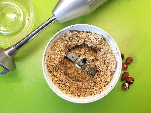 Almonds and hazelnuts are ground using a spice grinder.
