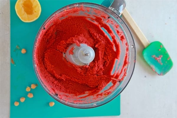 hummus made from cooked beets is blended in food processor.