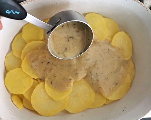 brown sauce is added to potatoes to make vegan scalloped potatoes.