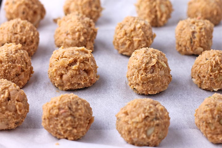 Bean balls are placed on baking tray with parchment paper.