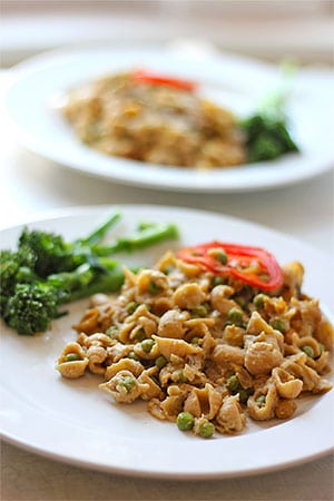 2 white plates with plant-based "tuna" casserole with broccoli spears.