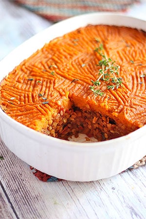 sweet potato Shepherd's pie in white casserole dish with serving cut out