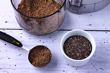 whole chia seeds in measuring small white dish and ground chia seeds in tablespoon