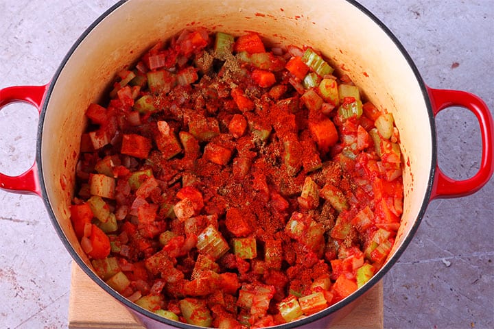 Smoked paprika, ground cumin and cinnamon is added to soup pot with diced celery, onions and carrots.