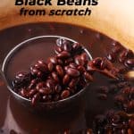 cooked black beans in red pot with liquid are lifted with a steel ladle with text overlay of recipe title