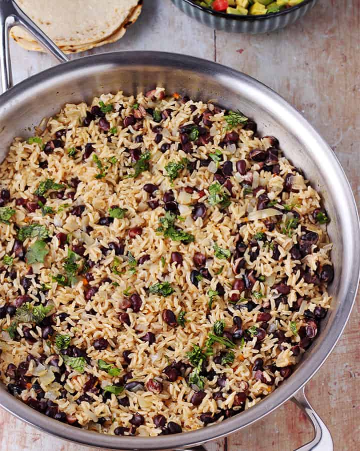 rice and beans with chopped cilantro in skillet