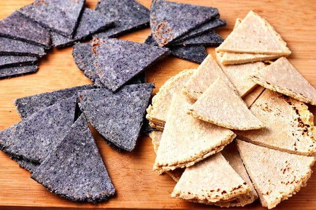 Blue and white corn tortilla chips on board