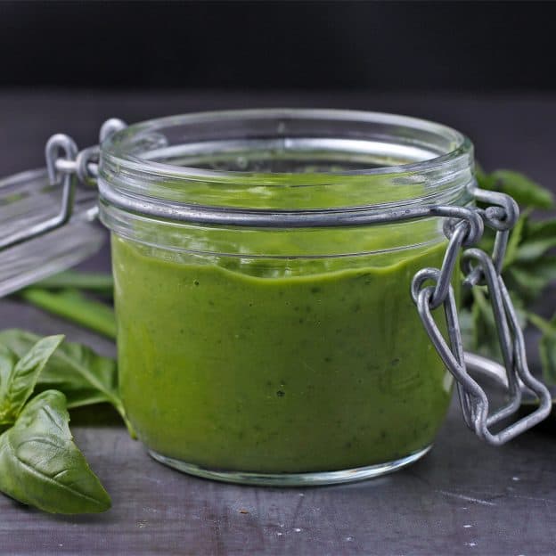 A jar is filled with healthy green goddess dressing.