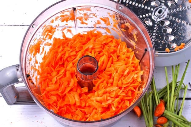Carrots are shredded in a food processor.