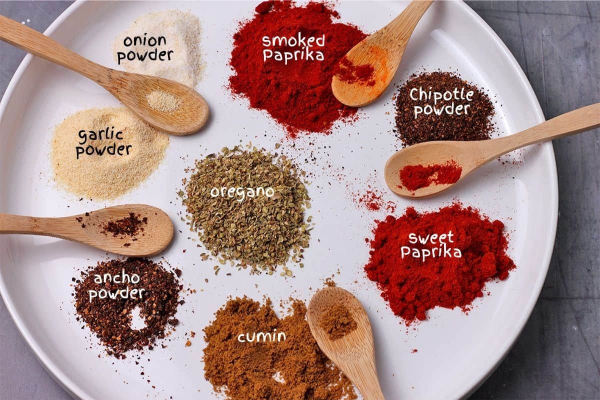 Homemade chili powder ingredients on a plate and labeled.