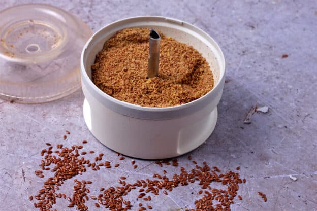 Flax seeds are ground in a spice grinder.