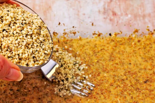 Hemp seeds are added to a mixture of miso paste, lemon juice, oregano, and salt.