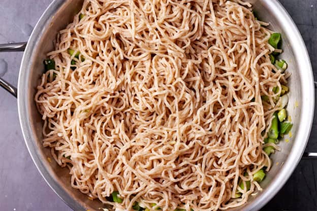 A skillet with cooked whole wheat noodles.