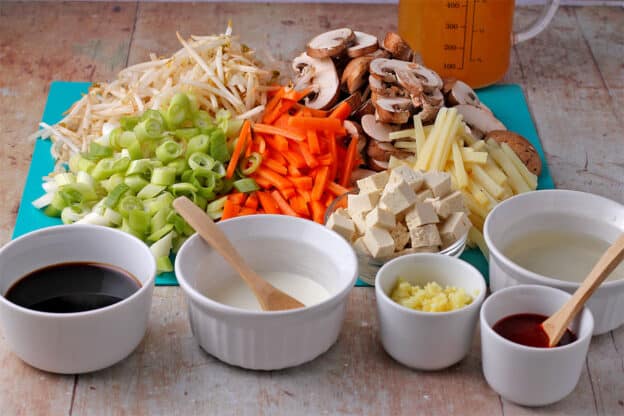 The ingredients for hot and sour soup are laid on a board.