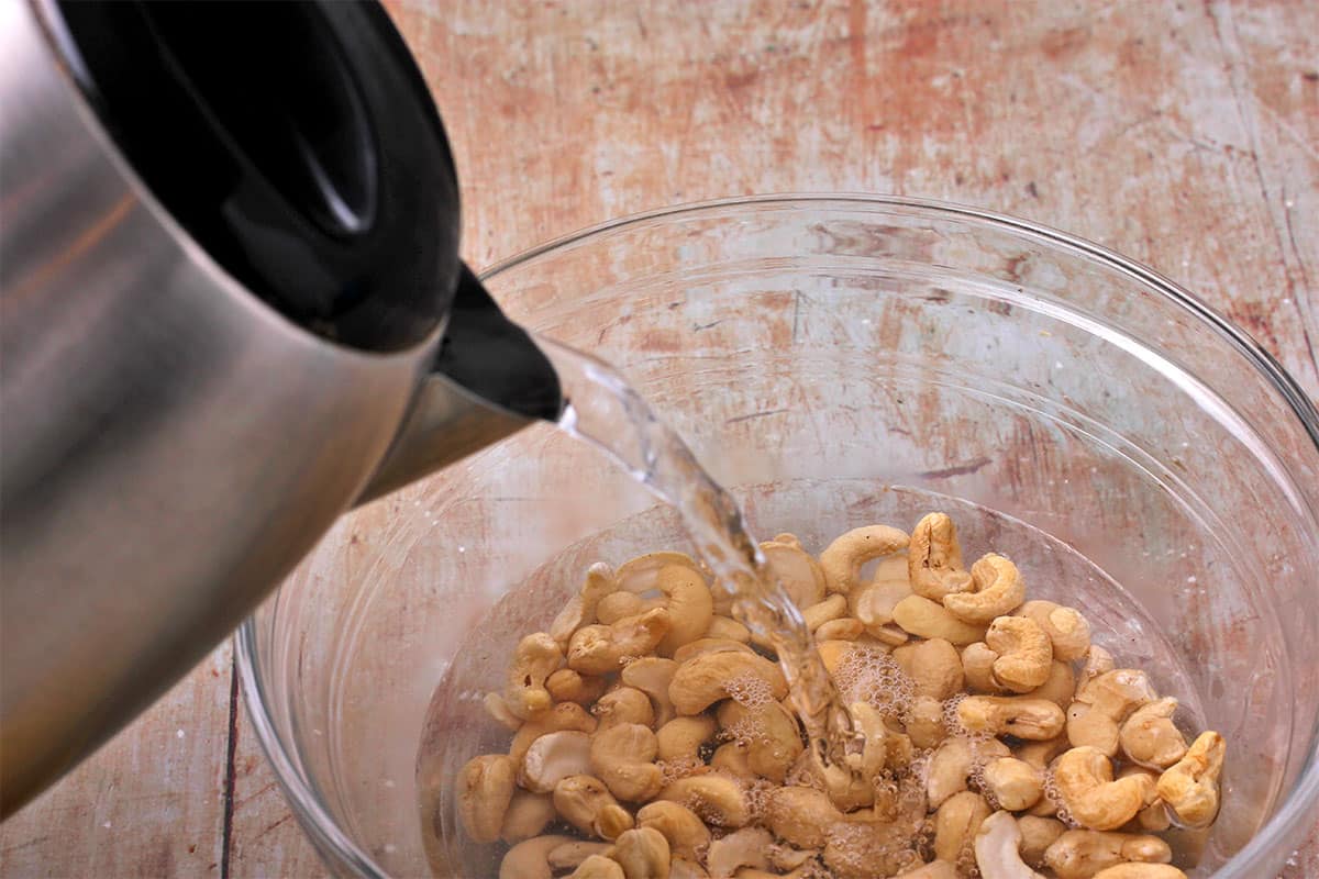 Water is poured over a bowl of cashews.