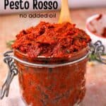 A jar filled with pesto Rosso with recipe title.