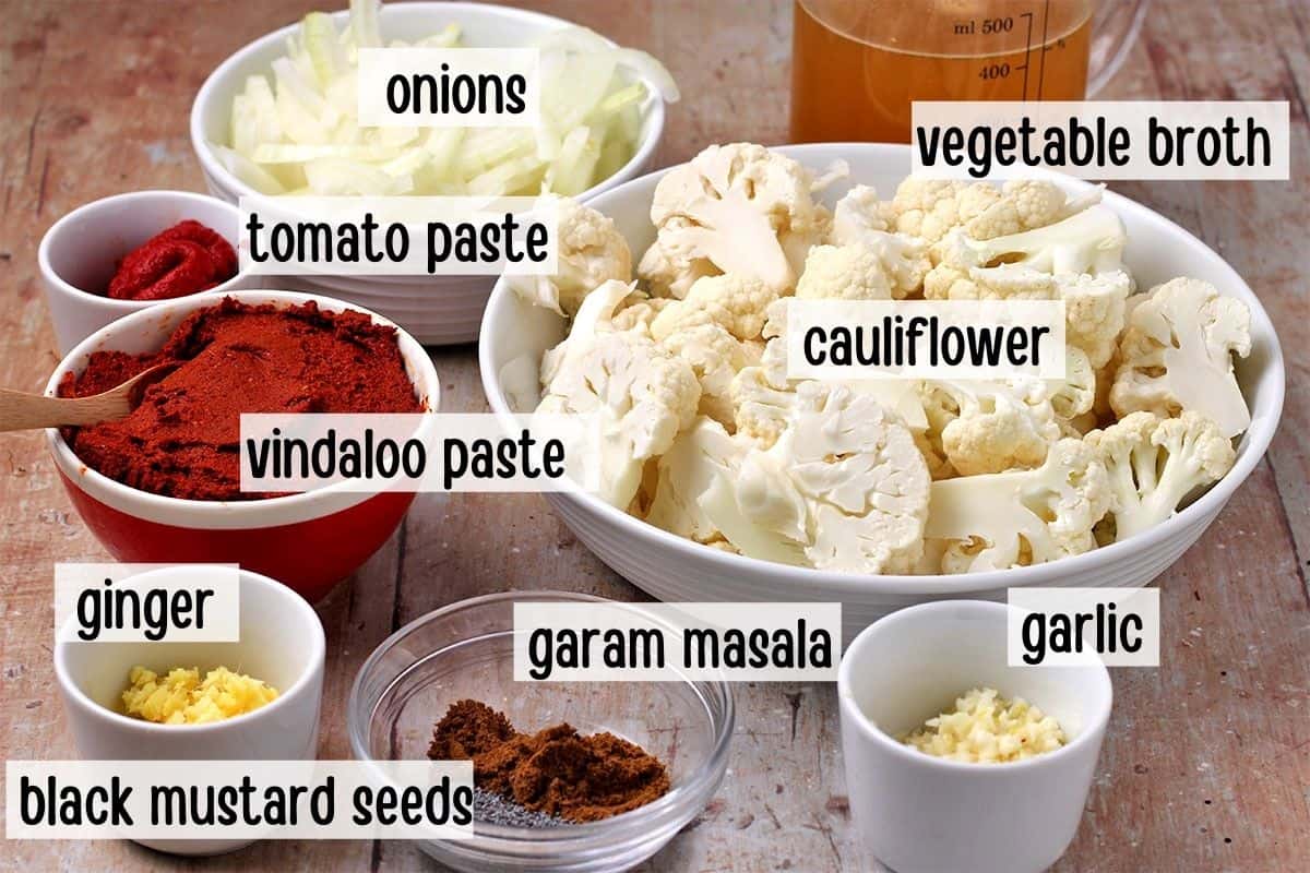 The ingredients for homemade vindaloo sauce with labels of the ingredients.
